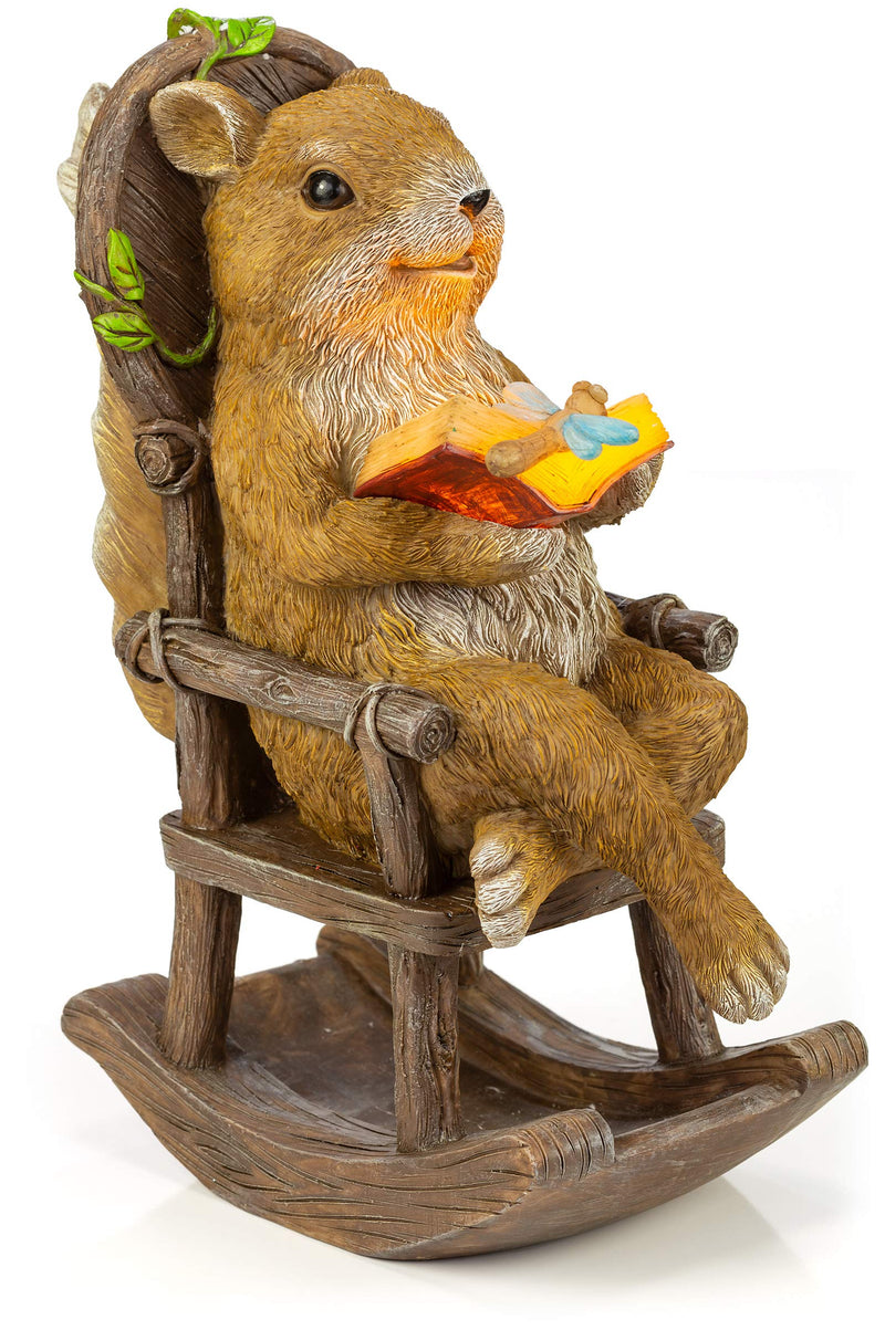 Squirrel reading and relaxing on a rocking chair with solar powered LED outdoor decoration